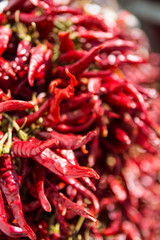 Dried red chilli paprika on a market stall with out of focus areas on the right.