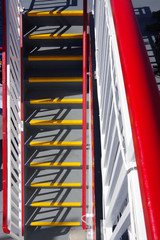 Stairs with red and white painted railings on a ferry ship