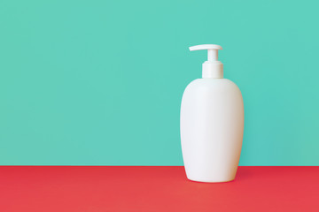 plastic cosmetic bottle on a color background, skin care tools concept