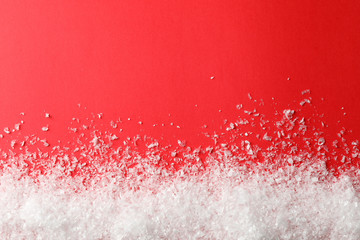 Snow on red background, space for text
