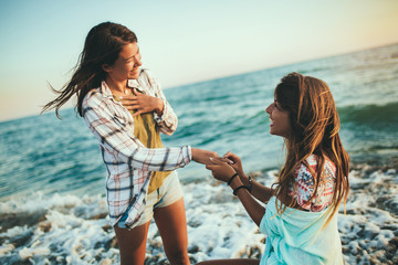 Pretty girl has a fun with her girlfriend on the beach