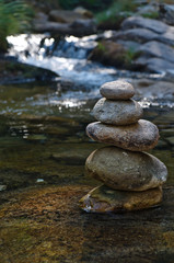 Fototapeta na wymiar Zen rocks or pebble stack on river waters. Peaceful and spiritual theme