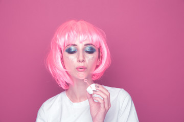 Young woman blowing soap bubbles. 90s style concept