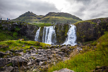 Kirkjufellsfoss, a summer morning down the waterfalls in a long exposure. Iceland