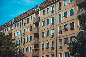 brown gdr building with small balcony