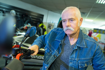 senior man hand steering motorcycle