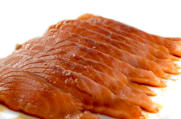 Thin Slices of Raw Salmon Fillet Isolated on White Background