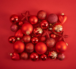 Christmas background. Set with a lot of different baubles over red background.