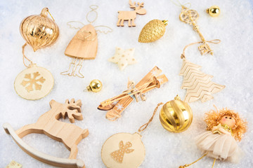 Christmas card. A lot of christmas gold baubles and decoration on snow