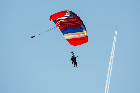 Tandem skydiving on a large parachute.
