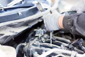 Car repair service. Mechanic working with a car in mechanical workshop