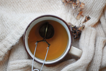 cup of tea on knitted sweater