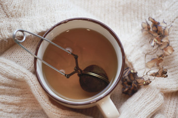 cup of tea on knitted sweater