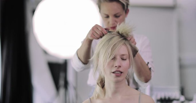 Model having hair styled on a photoshoot