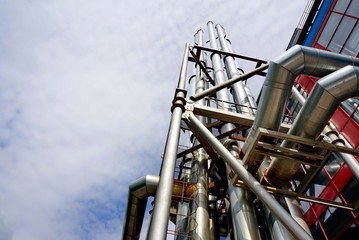 Fototapeta premium Ventilation pipes of a shopping center. Shiny steel, the sky.