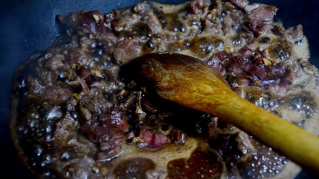 Cooking meatballs in tomato sauce to prepare spaghetti with meatball