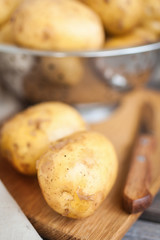 Raw potato. Fresh new potatoes on wooden background