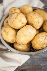 Raw potato. Fresh new potatoes on wooden background