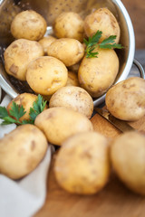 Raw potato. Fresh new potatoes on wooden background