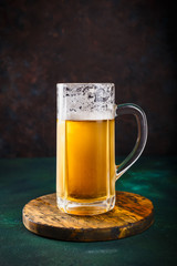 Mug of beer on dark background