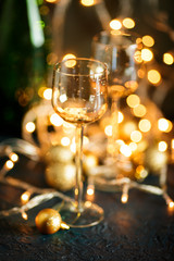 Glasses for wine and golden Christmas balls