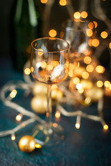 Glasses for wine and golden Christmas balls