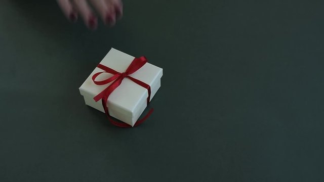 Close up view of woman hands giving a gift box