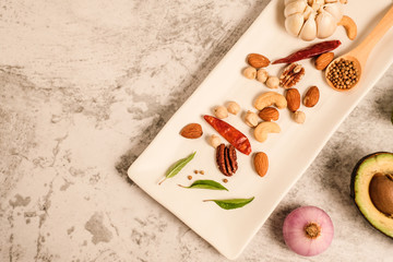 Garlic clove on stone top view .Flat lay composition with herb and nut seed