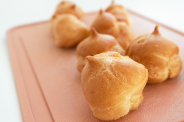 Puff cakes, close-up. Small tasty homemade baked profiterole