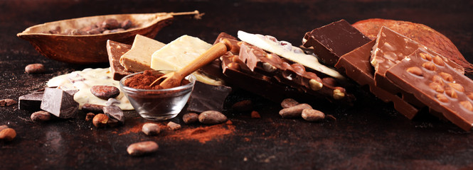 Melting chocolate, melted chocolate and chocolate swirl with stack and chips on table
