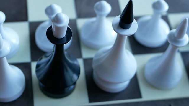camera moving from out of focus position into the chess battlefield where black queen standing among white figures. spy traitor concept 4k video footage