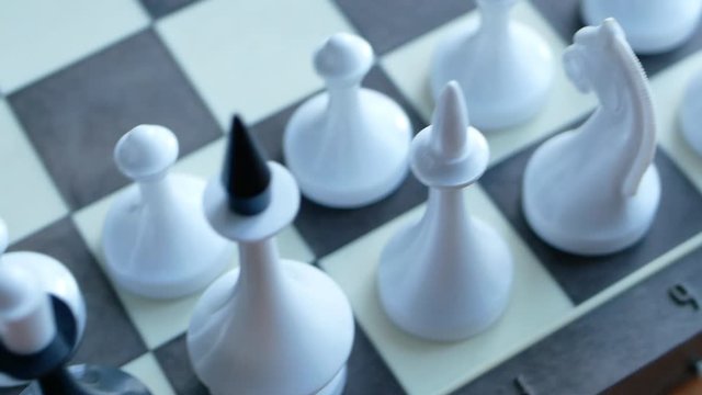 inspecting army and find a traitor. general observing his troops and suddenly find a betrayer. black chess spy queen among white figures. conceptual 4k video footage