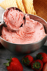 Strawberry ice cream scoop on a rustic white background