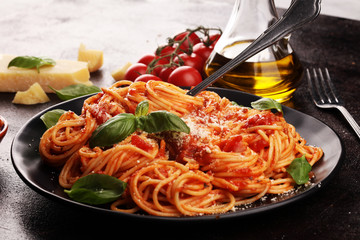 Plate of delicious spaghetti Bolognaise or Bolognese with savory minced beef and tomato sauce garnished with parmesan