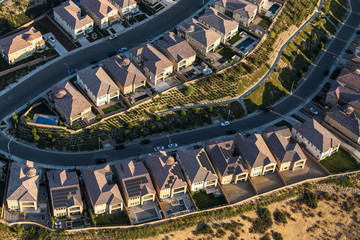 Aerial late afternoon view of suburban residential rooftops in the San Fernando Valley area of Los Angeles, California.