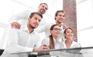 business team sitting at the table and looking forward