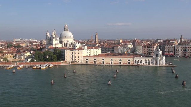 Aerial view video of Venice, Italy: waterfront with Grand Canal, Punta della Dogana and Basilica di Santa Maria della Salute (view from a cruise  liner on the Giudecca Canal)