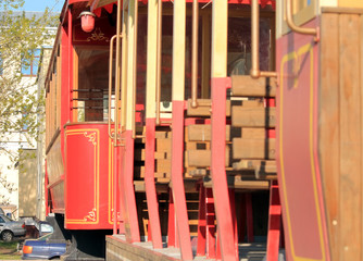 Fototapeta na wymiar old red tram on a stand