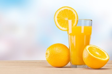 Orange juice and slices of orange on background