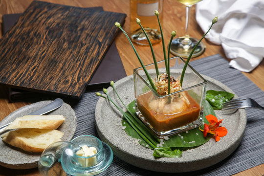 Prawn ballotine on lobster bisque. Exquisite dish. Creative restaurant meal. Fine dining concept.