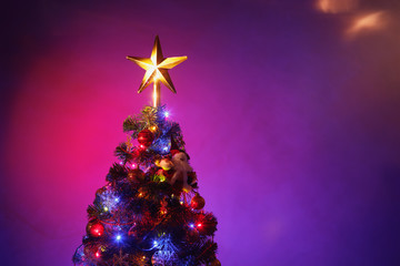 Christmas tree with festive star, purple background