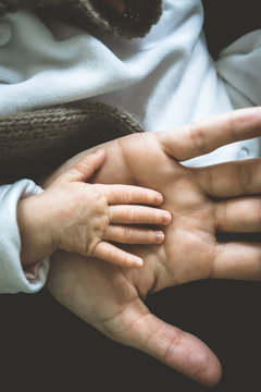 Close-up of a baby's hand in a parent's hand