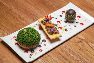 Dark chocolate egg with chou bun stuffed with chocolate cream. Creative restaurant dessert concept.
