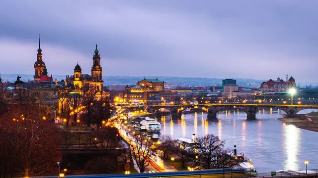 Dresden, Germany. Aerial view at main illuminated landmarks in the city of Dresden, Germany at sunset. Time-lapse from evening to night with car traffic and reflection in the river,  pan video