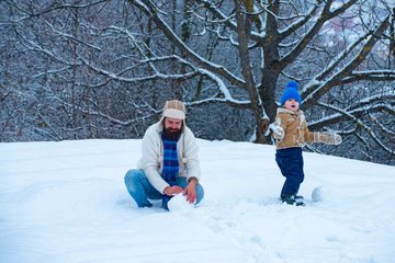 Happy father and son play on winter Christmas time.