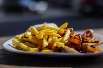 german currwurst with fries outside
