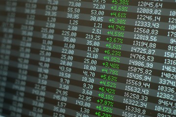 Stock market boom, skyrocketing prices. Green numbers across the board on a screen. Financial...