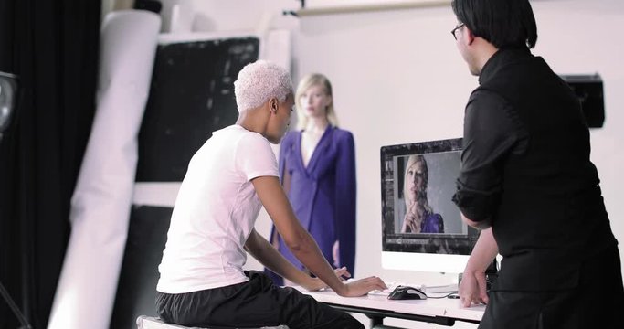 Photographer and client reviewing shots on a fashion shoot