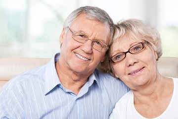 Portrait of happy senior couple smiling at home