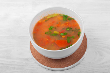 Vegetable soup with sliced carrots, peppers, tomatoes, beans and rice